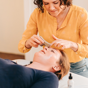 Patient napping while receiving gentle gua sha facial massage as part of cosmetic acupuncture at Seneca Falls Acupuncture.