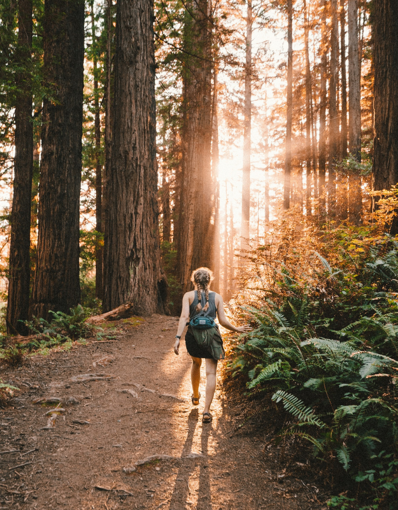 Reduce stress in whatever ways work best for you, such as hiking, like the woman in this photo.